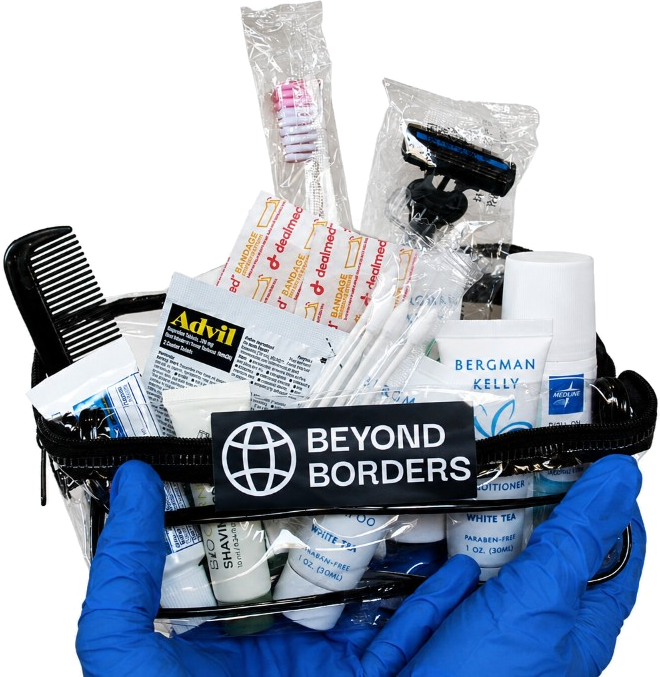 A Beyond Borders hygiene kit packed with travel-size toiletries, first-aid supplies, and health items.